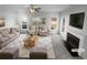 Bright living room features a fireplace, plush seating, and ample natural light at 4200 Flakes Mill Manor Ln, Ellenwood, GA 30294