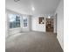 Open-concept living room with a view into kitchen with bay windows, and ample natural light at 4200 Flakes Mill Manor Ln, Ellenwood, GA 30294