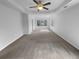 Main bedroom featuring tray ceiling, lots of windows, and neutral colors at 4200 Flakes Mill Manor Ln, Ellenwood, GA 30294