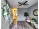 Inviting entrance with stylish gray walls, wood flooring, and modern ceiling fan creates a warm and welcoming ambiance at 7750 Carnegie Dr, Fairburn, GA 30213