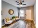 Cozy living room featuring stylish gray walls, wood flooring, and comfortable seating with natural light at 7750 Carnegie Dr, Fairburn, GA 30213