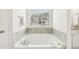Modern bathroom featuring a large soaking tub under a window with a view at 2021 Wyndham Pl, Conyers, GA 30013