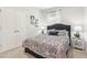 Cozy bedroom with patterned bedding, a large window, and a mirrored night stand at 2021 Wyndham Pl, Conyers, GA 30013