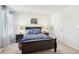 Cozy bedroom featuring a dark wood bed frame, side tables, and blue automobile themed bedding at 2021 Wyndham Pl, Conyers, GA 30013
