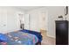 This bedroom boasts light gray walls and carpet, a black dresser, and an adjacent bathroom at 2021 Wyndham Pl, Conyers, GA 30013