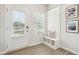 Bright entryway featuring a storage bench with decor, coat hooks, and natural light from the front door window at 2021 Wyndham Pl, Conyers, GA 30013