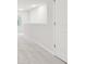 Hallway with light gray walls, light gray carpet, a window, white trim, and white door at 2021 Wyndham Pl, Conyers, GA 30013