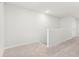 Hallway with light gray walls and light gray carpet with white trim and doors at 2021 Wyndham Pl, Conyers, GA 30013