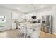 Modern kitchen featuring stainless steel appliances, granite counters, an island with seating, and white cabinets at 2021 Wyndham Pl, Conyers, GA 30013