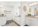 Well-lit main bathroom with tub, and dual vanity with granite countertops at 2021 Wyndham Pl, Conyers, GA 30013