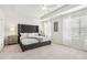 Bright main bedroom with tray ceiling, plush carpet, and multiple windows at 2021 Wyndham Pl, Conyers, GA 30013