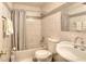 Bright bathroom featuring a shower-tub combination, tiled walls, and a stylish vanity at 2573 Mistletoe Ln, Snellville, GA 30039
