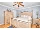 Charming bedroom features natural wood furniture, a ceiling fan, and hardwood floors at 2573 Mistletoe Ln, Snellville, GA 30039