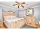 Spacious bedroom features natural wood furniture, a ceiling fan, and hardwood floors at 2573 Mistletoe Ln, Snellville, GA 30039
