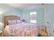 Inviting bedroom with a queen bed, wood floors and lots of natural light from the window at 2573 Mistletoe Ln, Snellville, GA 30039