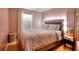 Cozy bedroom with hardwood floors, window, and a comfortable bed at 2573 Mistletoe Ln, Snellville, GA 30039