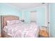 Inviting bedroom with a queen bed, wood floors and lots of natural light from the window at 2573 Mistletoe Ln, Snellville, GA 30039