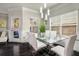 Stylish dining space with a glass-top table, white chairs, and a view of the outdoor greenery at 158 Bryon Ln Ln, Acworth, GA 30102