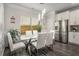 Bright dining area featuring a modern glass table, white chairs, and lots of natural light at 158 Bryon Ln Ln, Acworth, GA 30102