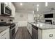 Open kitchen with stainless steel appliances, granite countertops, and a view into the dining and living areas at 158 Bryon Ln Ln, Acworth, GA 30102