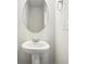 Pedestal sink bathroom features an oval mirror, towel ring, and dual outlets at 2023 Wyndham Pl, Conyers, GA 30013