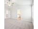Carpeted bedroom with ceiling fan, view into bathroom, and natural light from a window at 2023 Wyndham Pl, Conyers, GA 30013