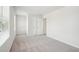 Bright, neutral bedroom featuring a closet, plush carpet, and natural light from a window with blinds at 2023 Wyndham Pl, Conyers, GA 30013