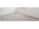 Well-lit bedroom with carpeted floors and a window providing ample natural light at 2023 Wyndham Pl, Conyers, GA 30013