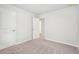 An open door shows access to another room and a carpeted bedroom at 2023 Wyndham Pl, Conyers, GA 30013