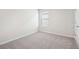 Bright bedroom with a window and carpeted flooring providing a comfortable space at 2023 Wyndham Pl, Conyers, GA 30013
