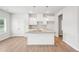 Bright kitchen features recessed lighting, granite counters, white cabinetry and stainless double basin sink at 2023 Wyndham Pl, Conyers, GA 30013