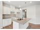 Bright kitchen features recessed lighting, granite counters, white cabinetry and stainless double basin sink at 2023 Wyndham Pl, Conyers, GA 30013