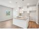 Bright kitchen features recessed lighting, granite counters, white cabinetry and stainless double basin sink at 2023 Wyndham Pl, Conyers, GA 30013