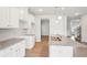 Bright kitchen features recessed lighting, granite counters, white cabinetry and stainless double basin sink at 2023 Wyndham Pl, Conyers, GA 30013