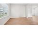 Bright living room area featuring wood-look flooring and a large window for plenty of natural light at 2023 Wyndham Pl, Conyers, GA 30013