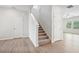 Carpeted stairs lead to the second level, next to a door to another room and an open area at 2023 Wyndham Pl, Conyers, GA 30013