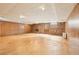Finished basement featuring wood paneled walls, brick accent wall and a door to the exterior at 5275 Redfield Ct, Atlanta, GA 30338