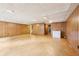 Spacious basement with wood paneled walls and access to the stairway at 5275 Redfield Ct, Atlanta, GA 30338