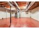 Unfinished basement with exposed ductwork, a red painted floor and water heater at 5275 Redfield Ct, Atlanta, GA 30338