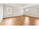 Bright bedroom featuring hardwood floors and three windows for ample natural light at 5275 Redfield Ct, Atlanta, GA 30338