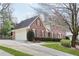 Beautiful two-story brick home with a well-manicured lawn and an attached two-car garage at 5275 Redfield Ct, Atlanta, GA 30338