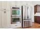 Modern kitchen with stainless steel oven, refrigerator, and light-colored custom cabinetry at 5275 Redfield Ct, Atlanta, GA 30338