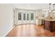 Spacious kitchen area with wood floors, bay windows, and custom cabinetry at 5275 Redfield Ct, Atlanta, GA 30338