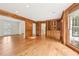 Open living area featuring hardwood floors, wood-paneled walls, and large windows at 5275 Redfield Ct, Atlanta, GA 30338