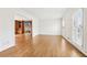 Open living area with hardwood floors, shuttered windows and an adjacent living area at 5275 Redfield Ct, Atlanta, GA 30338