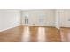 Large living area featuring hardwood floors, white walls, and shuttered windows at 5275 Redfield Ct, Atlanta, GA 30338