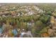 Aerial view showing the neighborhood, surrounded by mature trees, houses, and amenities at 935 Old Loganville Rd, Loganville, GA 30052