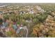 Aerial view of a home on a wooded lot in a suburban neighborhood surrounded by mature trees at 935 Old Loganville Rd, Loganville, GA 30052
