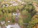 Aerial view of a home on a large lot surrounded by trees and other homes in the distance at 935 Old Loganville Rd, Loganville, GA 30052