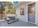 Back porch with table and benches providing plenty of space for outdoor dining at 935 Old Loganville Rd, Loganville, GA 30052